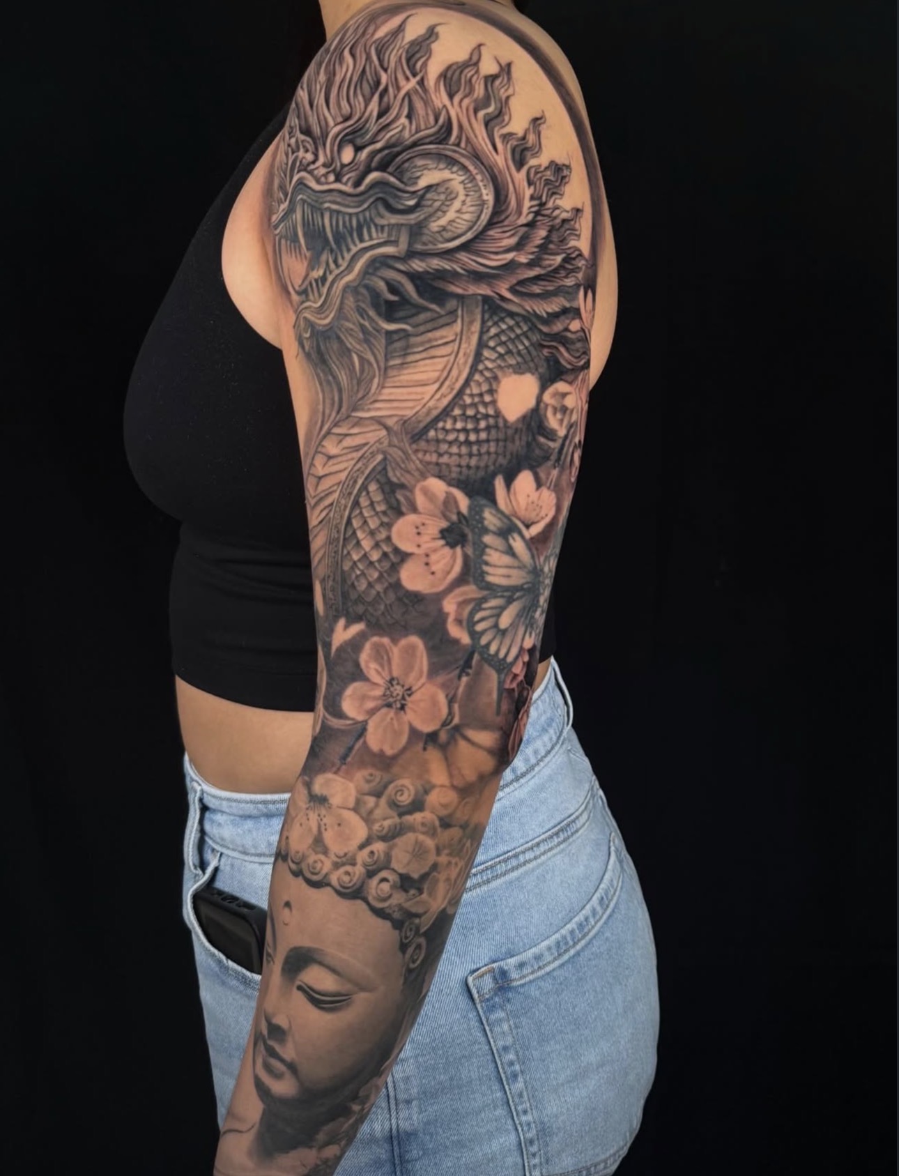 Black and grey dragon, Buddha and cherry blossom full sleeve tattoo by Sandra