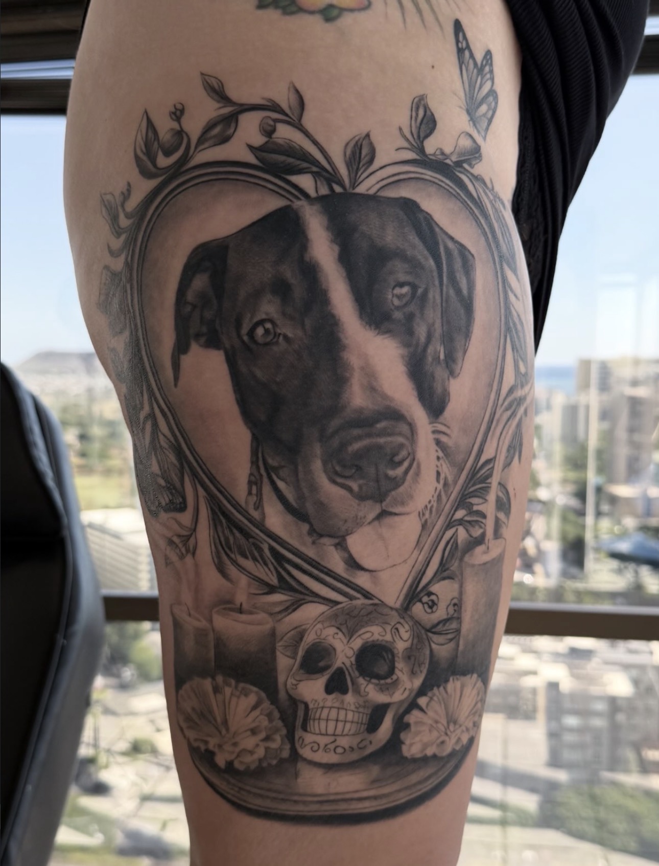 Black and grey dog portrait memorial thigh tattoo with candles and sugar skull by Sandra